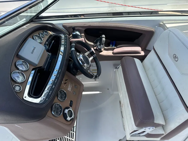 Slide: The Image of Interior of a 2012 Cobalt 302 boat with steering wheel and dashboard controls. - 5