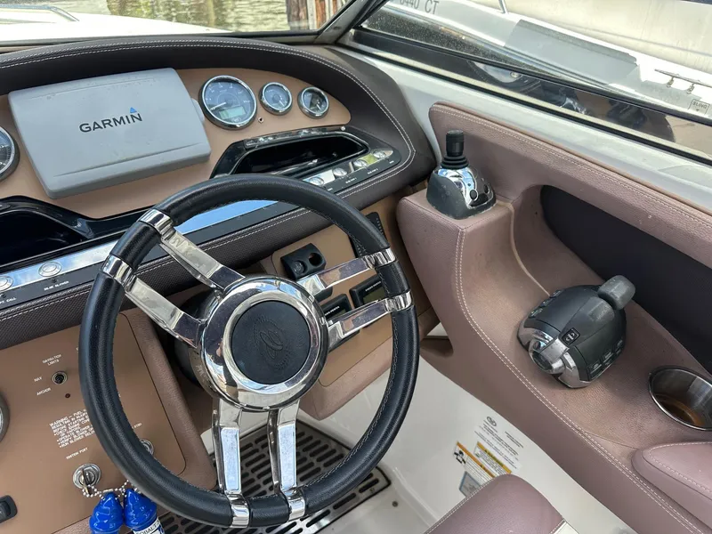 Slide: The Image of Steering wheel and dashboard of a 2012 Cobalt 302 boat with Garmin navigation. - 7