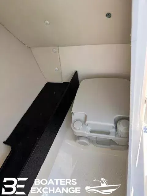 Slide: The Image of 2016 Yamaha Boats 242 LTD S interior storage compartment with portable toilet. - 10