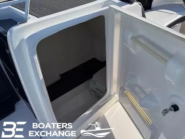 Slide: The Image of 2016 Yamaha Boats 242 LTD S storage compartment, open door, Boaters Exchange logo visible. - 9