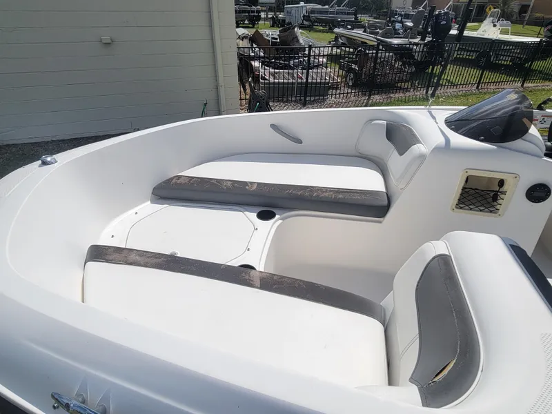 Slide: The Image of 2019 Bayliner Element E16 boat interior with cushioned seating and storage compartments. - 10
