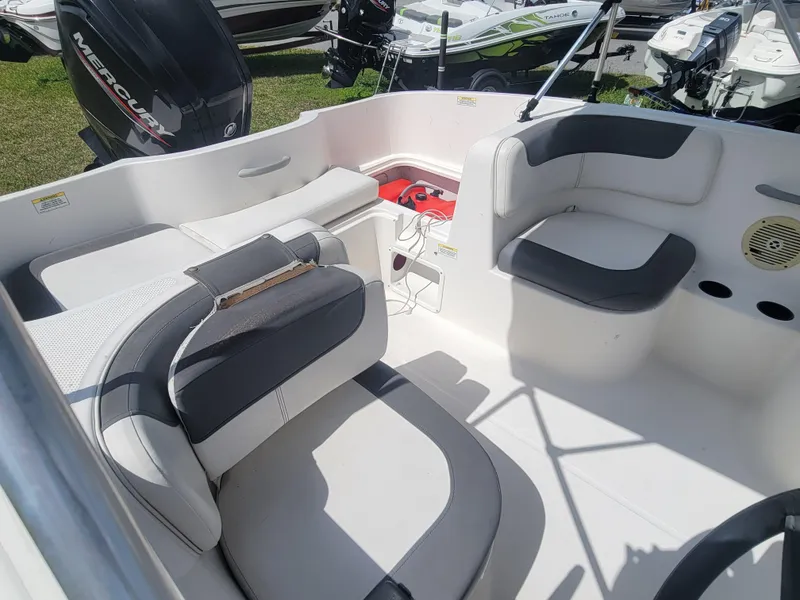 Slide: The Image of 2019 Bayliner Element E16 boat interior with cushioned seating and storage compartments. - 12