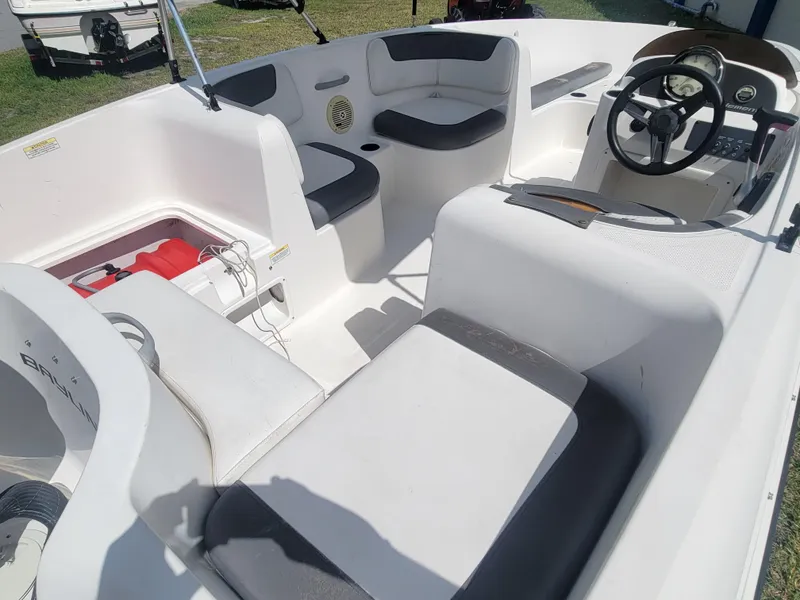 Slide: The Image of 2019 Bayliner Element E16 boat interior with seating and steering wheel. - 14