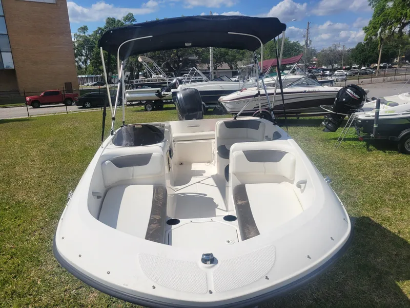 Slide: The Image of 2019 Bayliner Element E16 boat with canopy, displayed on grass under a sunny sky. - 2