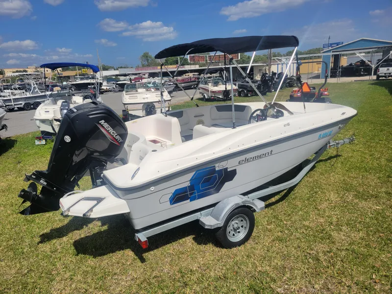 Slide: The Image of 2019 Bayliner Element E16 boat on trailer, displayed outdoors under sunny skies. - 4