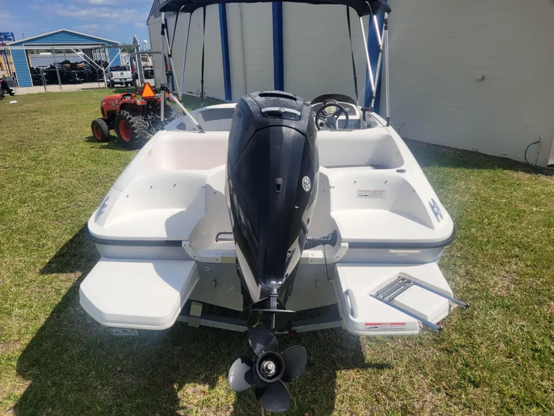 Slide: The Image of 2019 Bayliner Element E16 boat with outboard motor, parked on grass. - 5