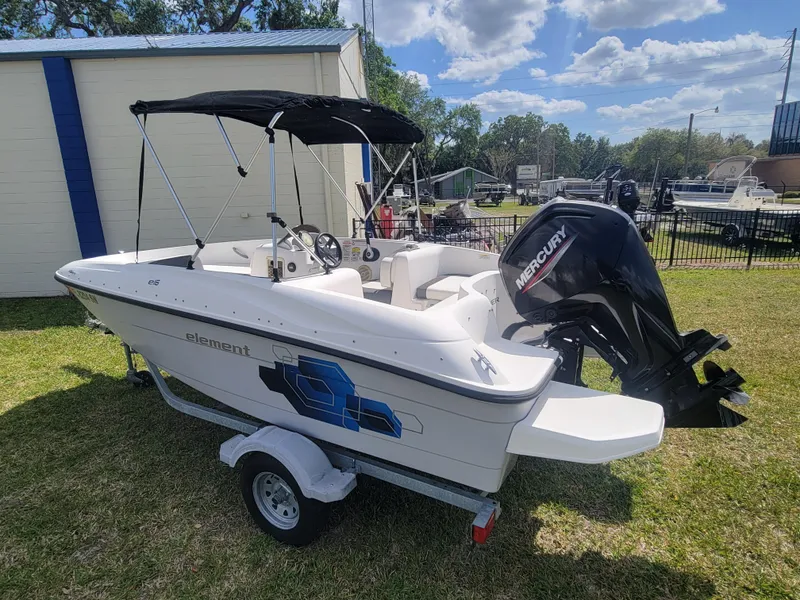 Slide: The Image of 2019 Bayliner Element E16 boat with Mercury engine on trailer, parked outdoors. - 6