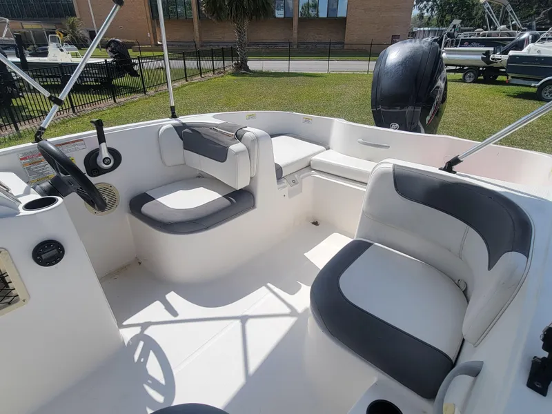 Slide: The Image of 2019 Bayliner Element E16 boat interior with seating and steering wheel. - 8