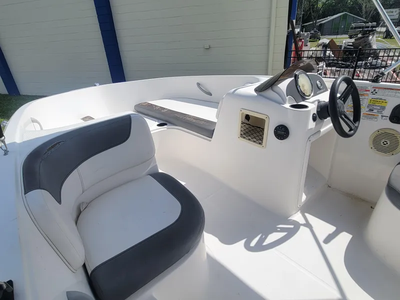 Slide: The Image of 2019 Bayliner Element E16 boat interior with steering wheel and seating. - 9