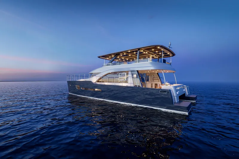 Slide: The Image of 2025 Catamaran HS 65 yacht on calm ocean at sunset. - 26