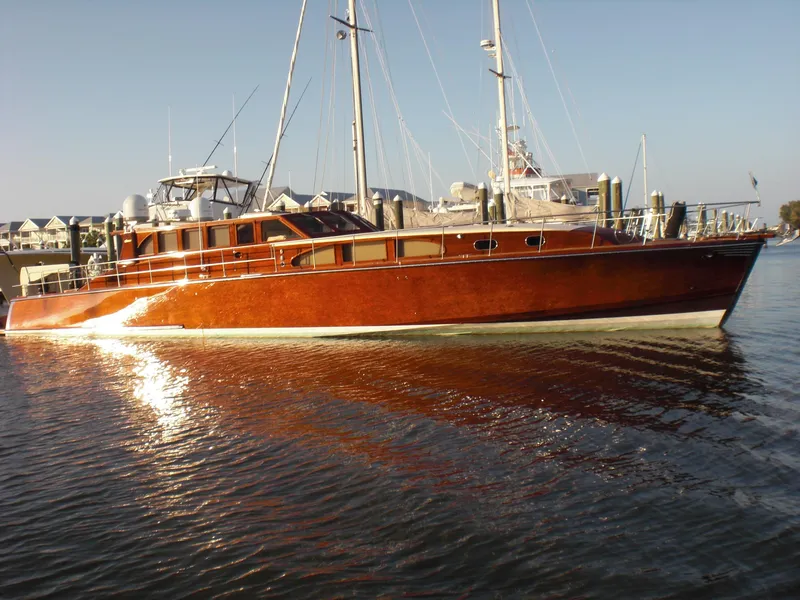 The Image of Luxurious 2009 Hugh Saint 65 Commuter yacht docked in a serene marina setting. - 0