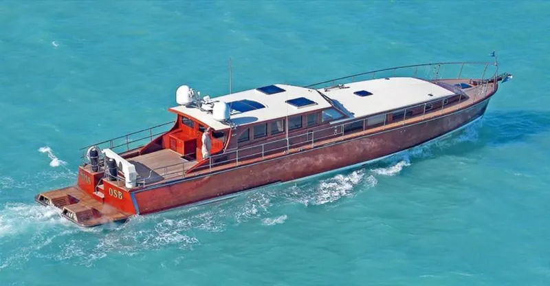 Slide: The Image of 2009 Hugh Saint 65 Commuter boat cruising on turquoise water. - 2