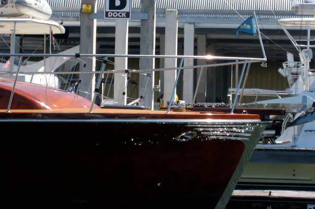 Slide: The Image of Hugh Saint 65 Commuter boat docked, 2009 model, at marina with other vessels. - 5