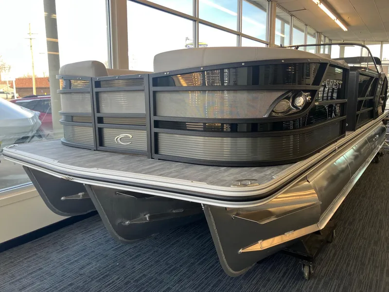 Slide: The Image of 2025 Crest Continental 250 SLS pontoon boat displayed indoors, showcasing sleek design and modern features. - 0