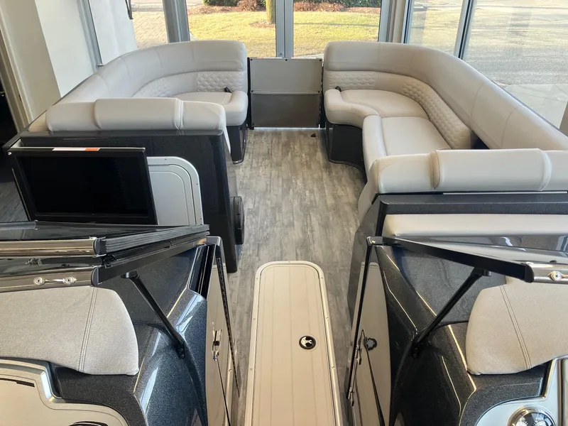 Slide: The Image of Luxurious interior of 2025 Crest Continental 250 SLS pontoon boat with plush seating. - 11