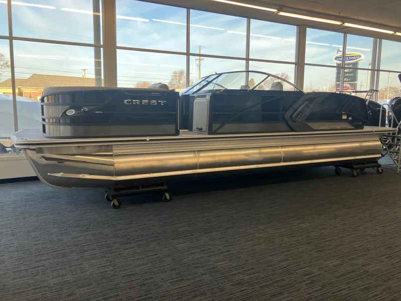 Slide: The Image of 2025 Crest Continental 250 SLS pontoon boat displayed indoors. - 2