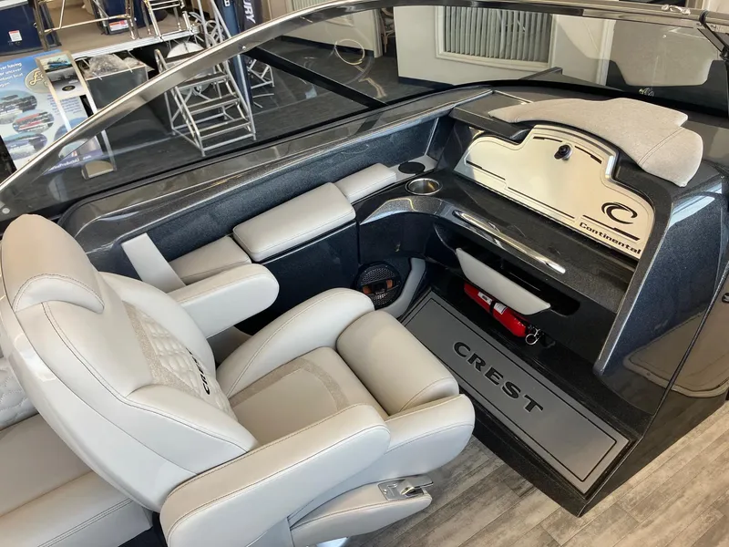 Slide: The Image of Interior of 2025 Crest Continental 250 SLS boat with luxurious seating and modern dashboard. - 7