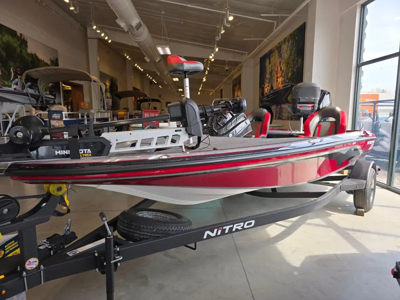 The Image of 2025 Nitro Z18 Pro bass boat in showroom, featuring sleek red design and advanced fishing technology. - 0