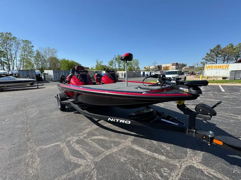 Slide: The Image of 2025 Nitro Z19 boat in parking lot, featuring sleek design and red accents. - 1