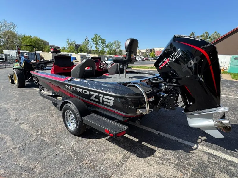 Slide: The Image of 2025 Nitro Z19 boat with powerful engine, parked on a trailer in a sunny outdoor setting. - 4