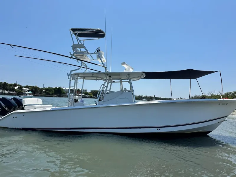 Slide: The Image of 2004 Palmetto 33 Adventure boat on calm water, featuring a sleek design and canopy. - 1