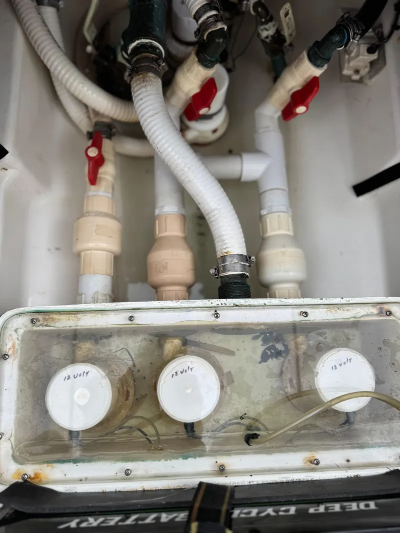 Slide: The Image of Plumbing system of a 2004 Palmetto 33 Adventure boat with visible pipes and valves. - 10