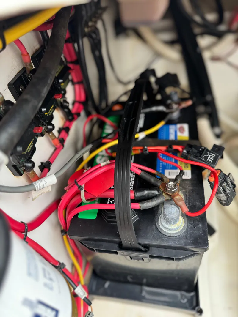 Slide: The Image of Battery setup in a 2004 Palmetto 33 Adventure boat with connected cables. - 11