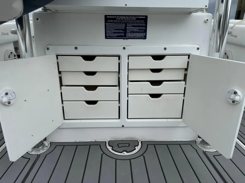 Slide: The Image of Open storage compartment with drawers on a 2004 Palmetto 33 Adventure boat. - 15