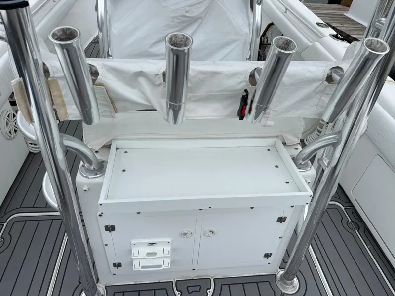 Slide: The Image of 2004 Palmetto 33 Adventure boat with rod holders and storage compartment. - 16