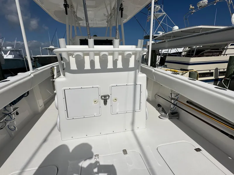 Slide: The Image of 2006 Island Runner 35 boat deck with rod holders and storage compartments. - 29