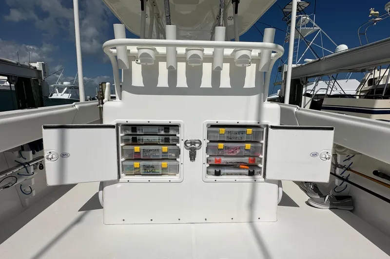 Slide: The Image of Open storage compartments on a 2006 Island Runner 35 boat, showcasing organized fishing gear. - 30