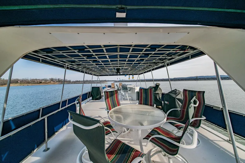 Slide: The Image of Upper deck of 1997 Stardust Cruisers 72x16 houseboat with seating, overlooking calm water. - 15