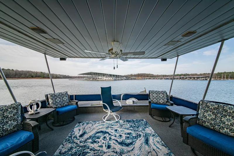 Slide: The Image of Luxurious 1997 Stardust Cruisers 72x16 houseboat interior with elegant seating and scenic lake view. - 18