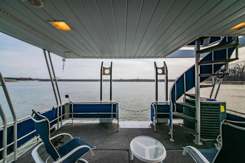 Slide: The Image of 1997 Stardust Cruisers 72x16 houseboat deck with spiral staircase and lake view. - 20