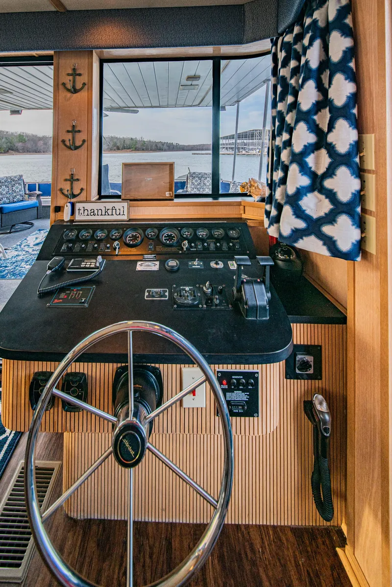 Slide: The Image of Helm of 1997 Stardust Cruisers 72x16 houseboat with nautical decor and lake view. - 25
