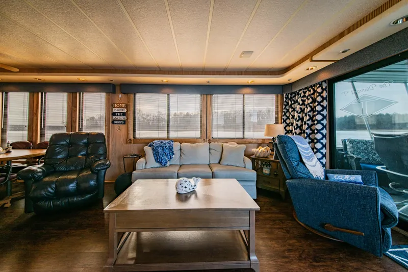 Slide: The Image of Cozy living area inside a 1997 Stardust Cruisers 72x16 houseboat with comfortable seating. - 26
