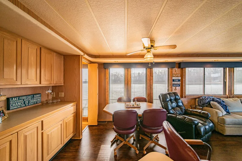 Slide: The Image of Interior of 1997 Stardust Cruisers 72x16 houseboat with cozy seating and wooden cabinetry. - 30
