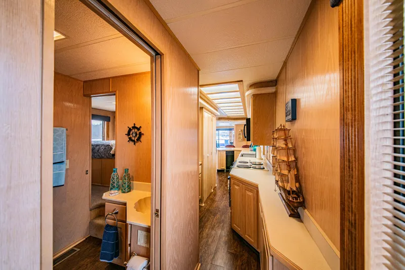 Slide: The Image of Interior of 1997 Stardust Cruisers 72x16 houseboat with wooden decor and nautical theme. - 34