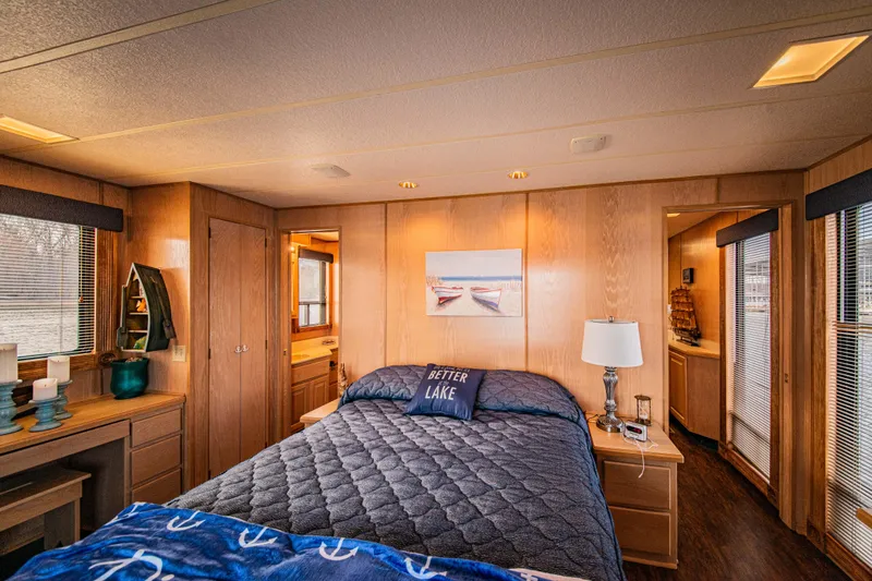 Slide: The Image of Cozy bedroom in 1997 Stardust Cruisers houseboat with wood paneling and nautical decor. - 36