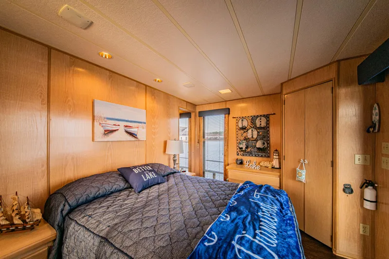 Slide: The Image of Cozy bedroom in 1997 Stardust Cruisers houseboat with nautical decor and lake view. - 37