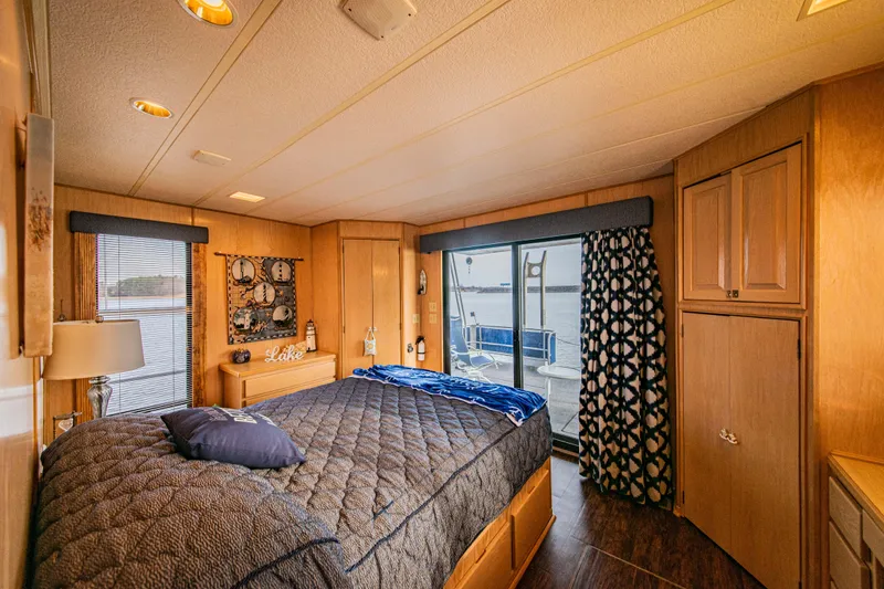 Slide: The Image of Luxurious 1997 Stardust Cruisers 72x16 houseboat bedroom with lake view and elegant decor. - 38