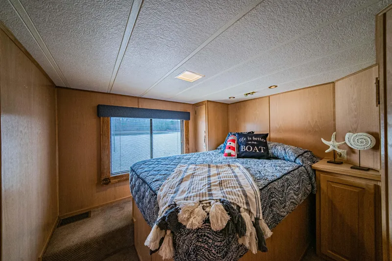Slide: The Image of Cozy bedroom in 1997 Stardust Cruisers 72x16 houseboat with nautical decor. - 39