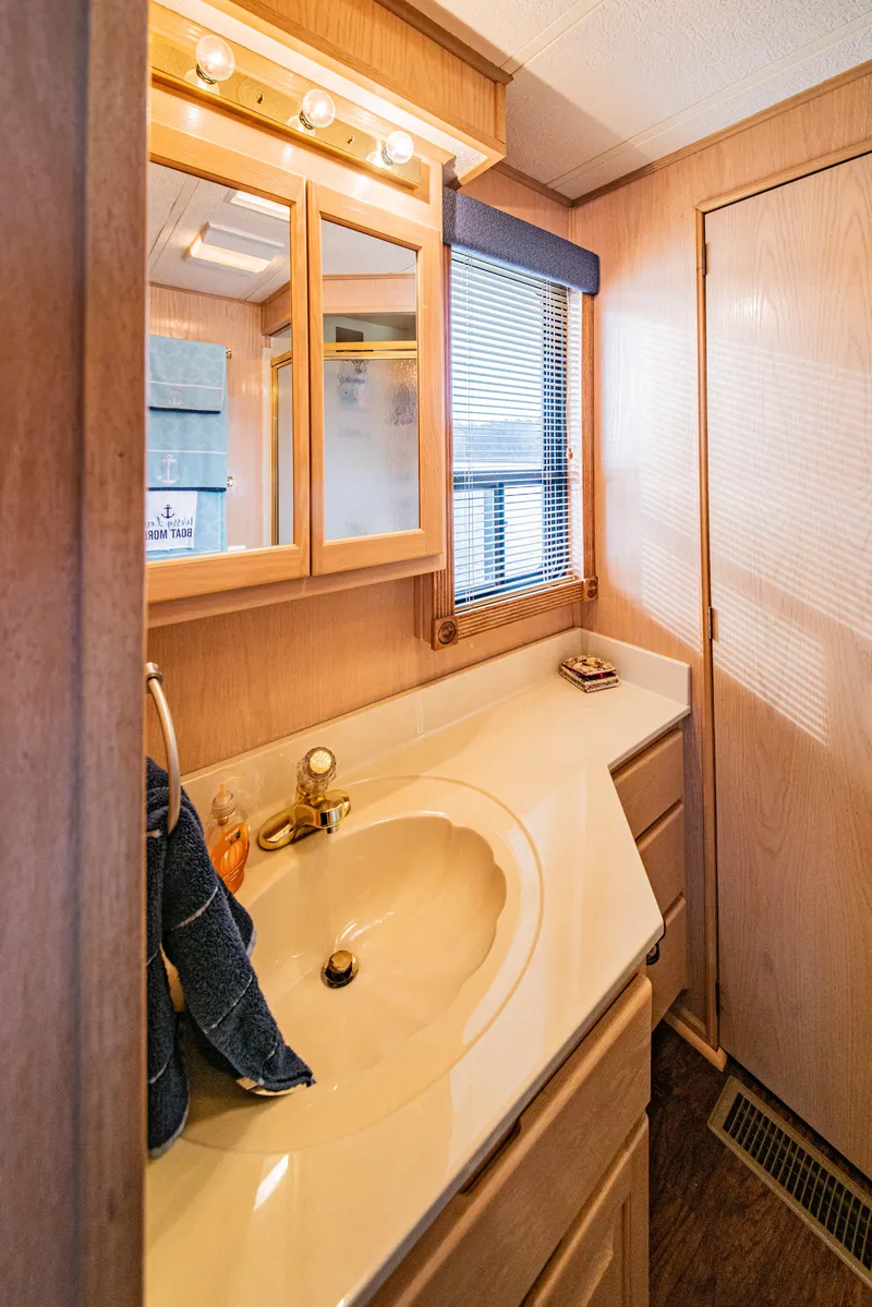 Slide: The Image of Bathroom interior of 1997 Stardust Cruisers 72x16 houseboat with wooden cabinetry and vanity. - 41