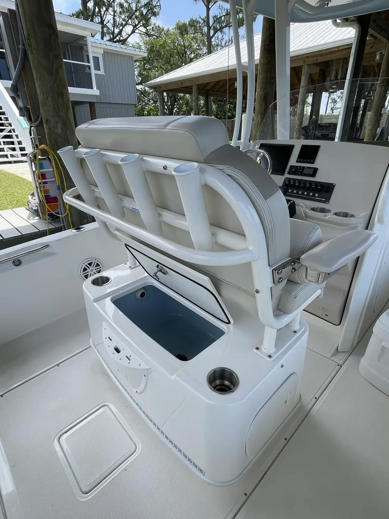 Slide: The Image of 2022 Boston Whaler 220 Dauntless boat interior with seating and storage features. - 10