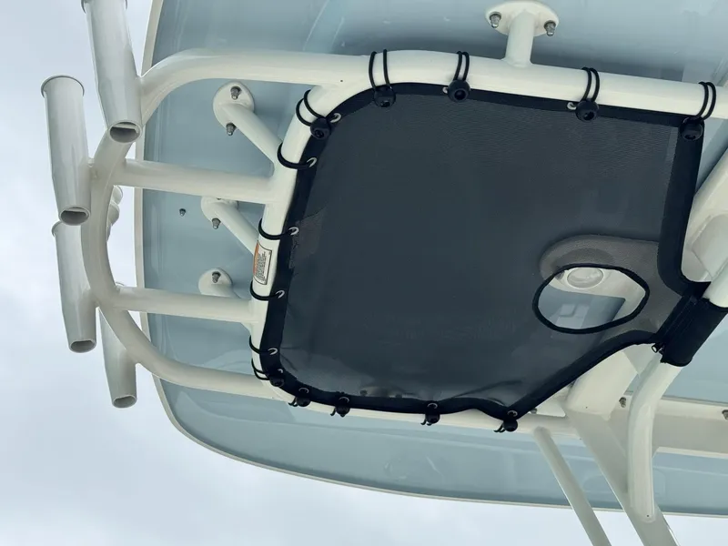 Slide: The Image of 2022 Boston Whaler 220 Dauntless T-top with rod holders and netting, viewed from below. - 13