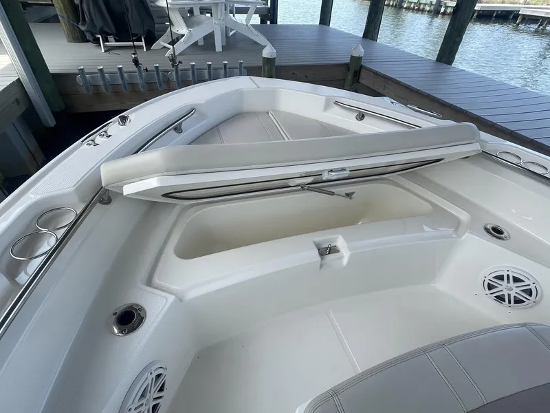 Slide: The Image of 2022 Boston Whaler 220 Dauntless boat interior with open storage compartment. - 18