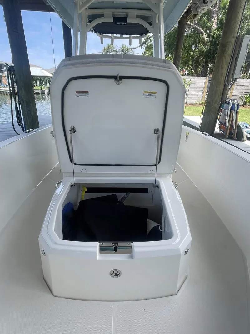 Slide: The Image of 2022 Boston Whaler 220 Dauntless boat with open storage compartment. - 20