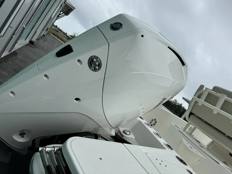 Slide: The Image of 2022 Boston Whaler 220 Dauntless boat engine, close-up view, overcast sky background. - 7