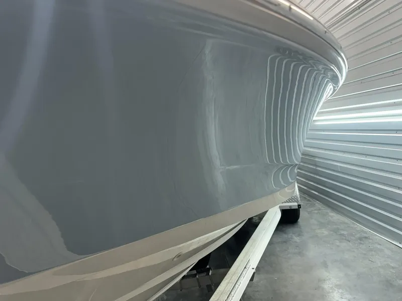 Slide: The Image of 2022 Boston Whaler 220 Dauntless boat hull in storage, side view. - 8