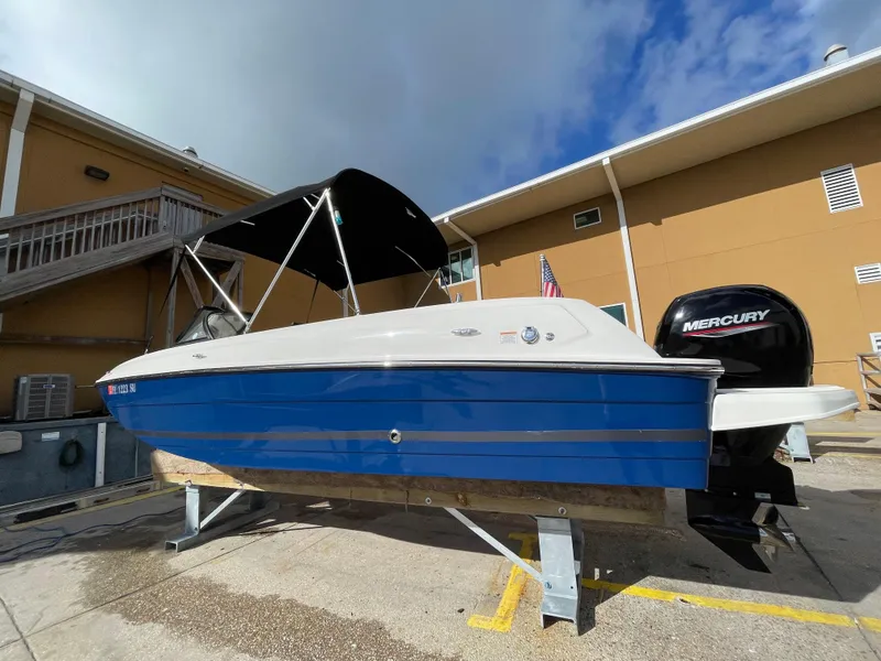 Slide: The Image of 2021 Bayliner Element E21 boat with blue hull and Mercury outboard motor. - 13